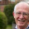 Tom Whitaker smiling outside his terraced home